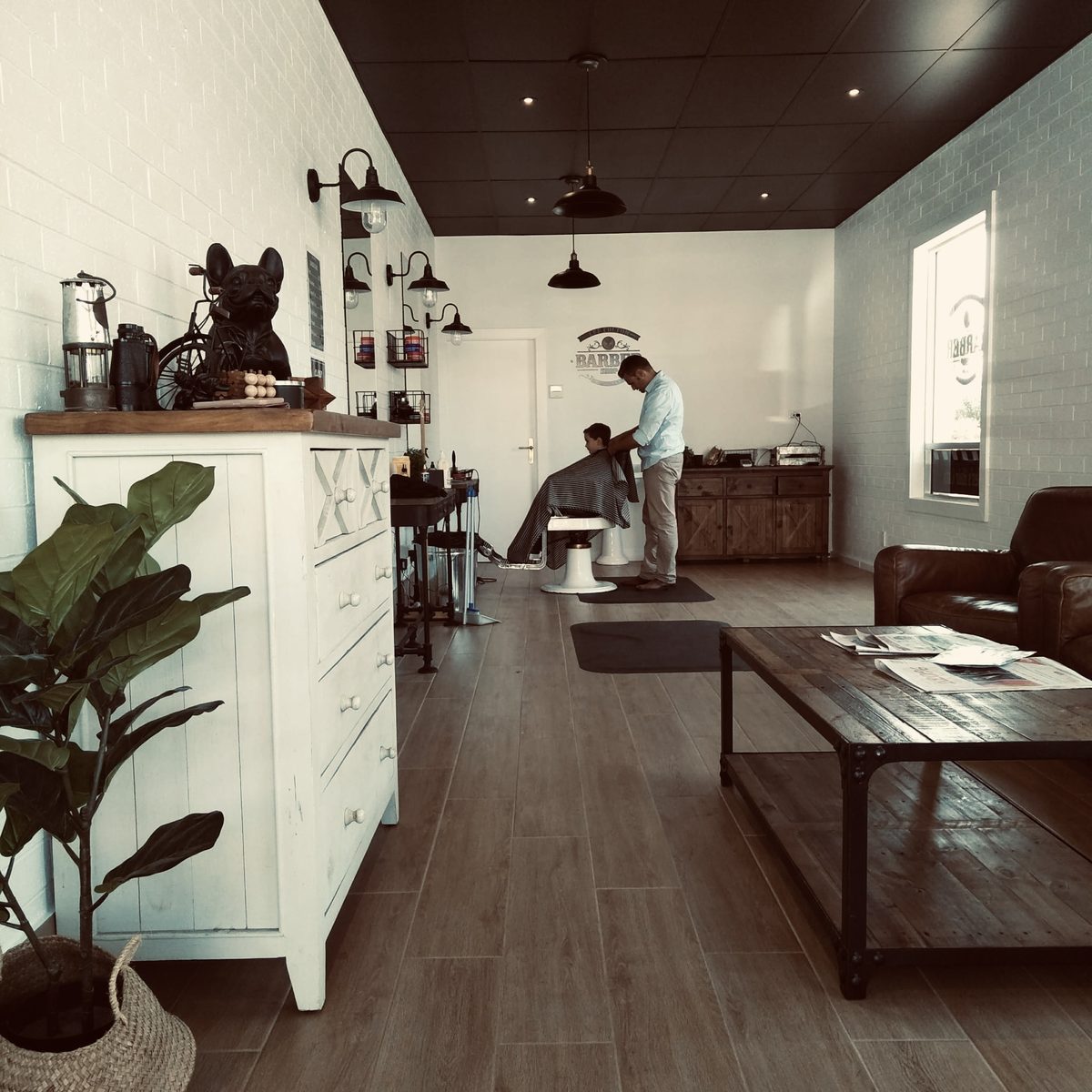 Inside the barber shop, view of the waiting area and barber chair